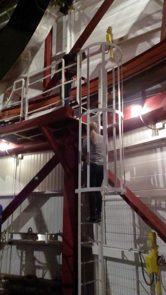 Me climbing up the ladder to the catwalk. Katie is leaning over to warn me not to touch the orange stuff, which is insulating some high voltage wires.