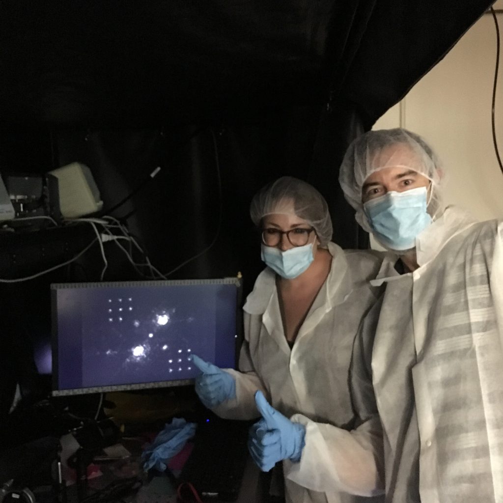 Jared and Kelsey pose with an image taken through the vAPP coronagraph.